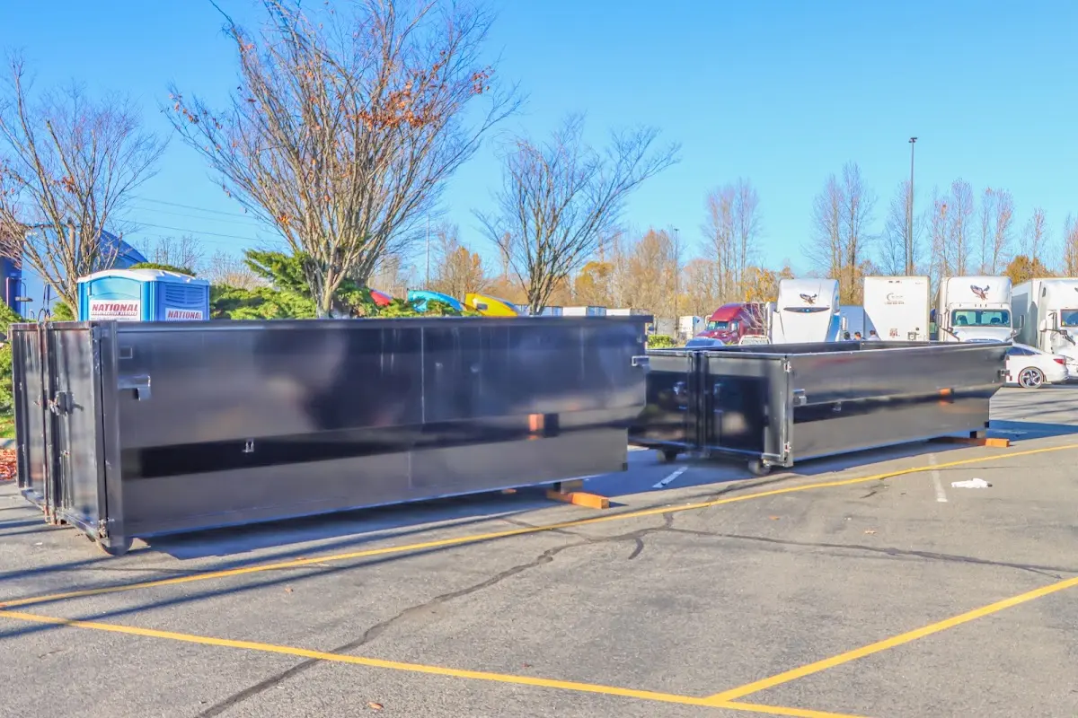 Professional dumpster rental service with roll-off container on residential driveway in Hillcrest